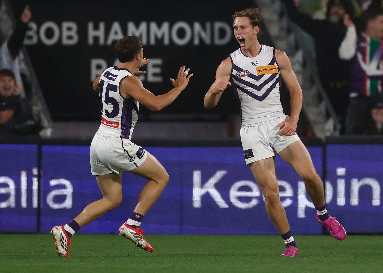 Matthew Johnson and Christopher Scerri celebrate a Dockers goal.