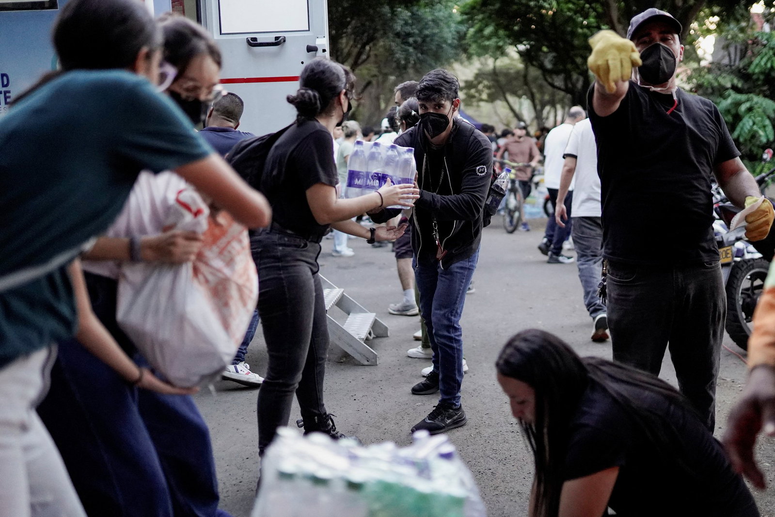 Colombians handing out packs of water