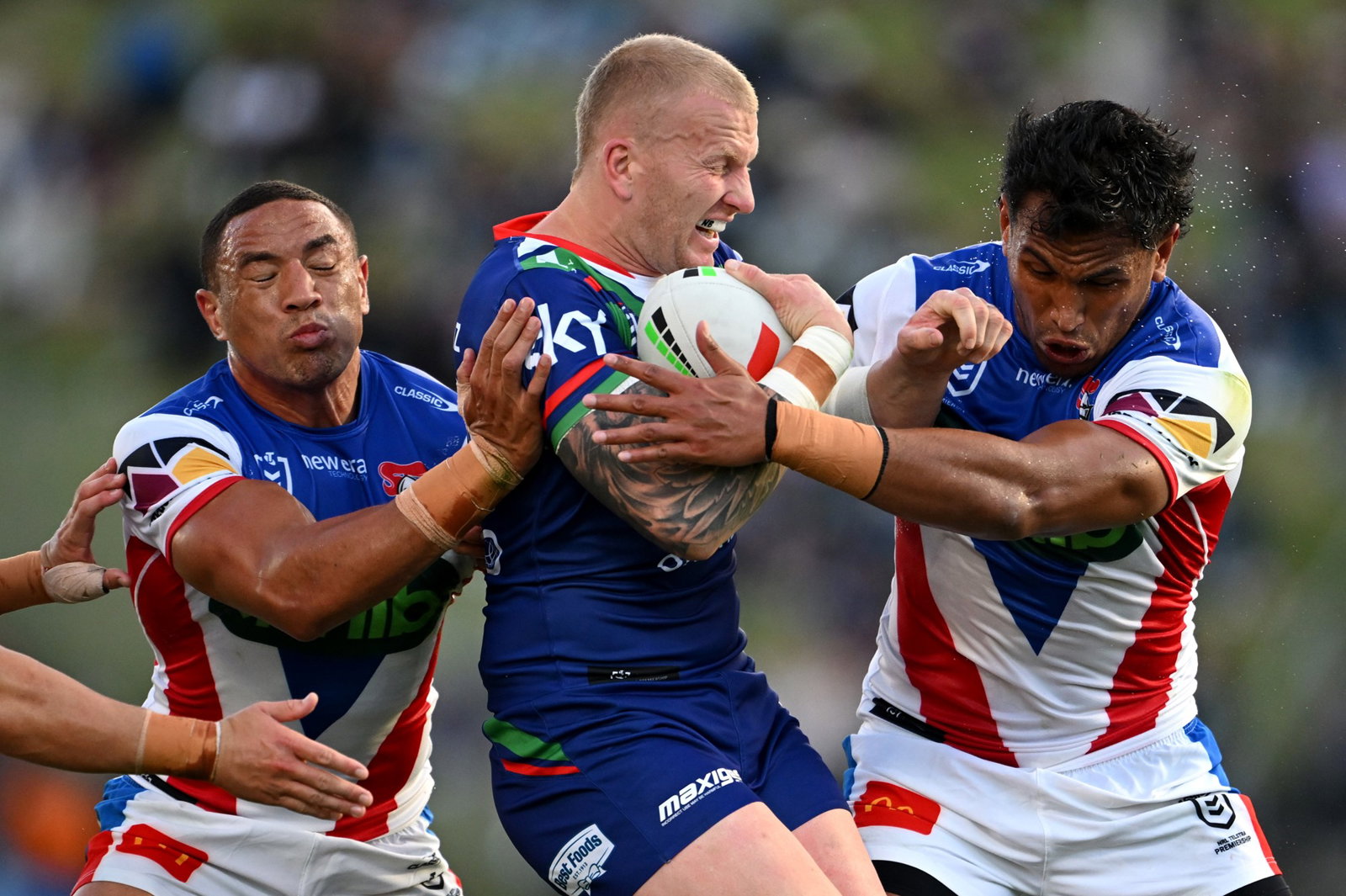 Mitchell Barnett runs into Newcastle Knights tacklers during an NRL game.