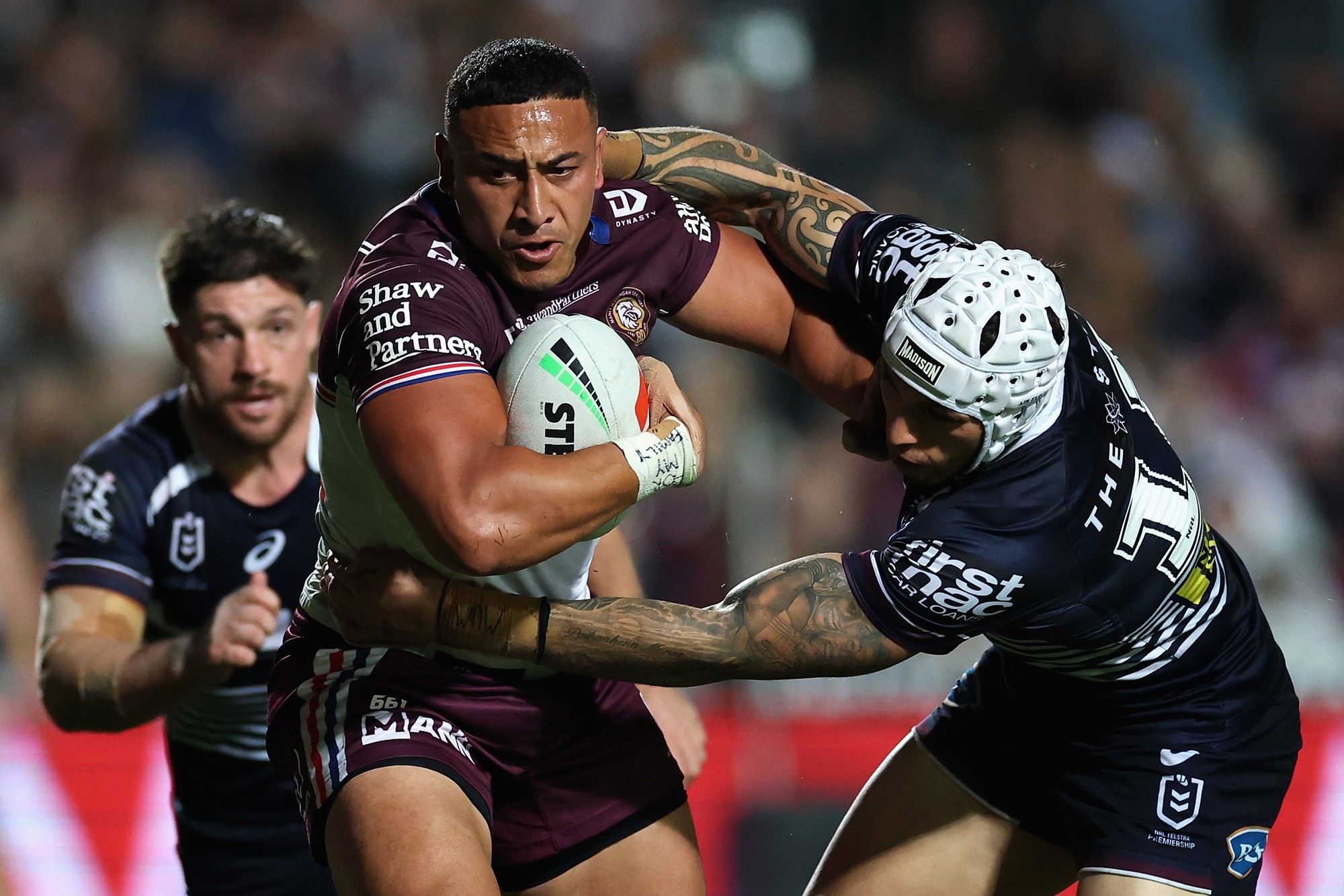 Siosiua Taukeiaho of the Sea Eagles heads for the goal-line after breaking the tackle of Jordan Riki,