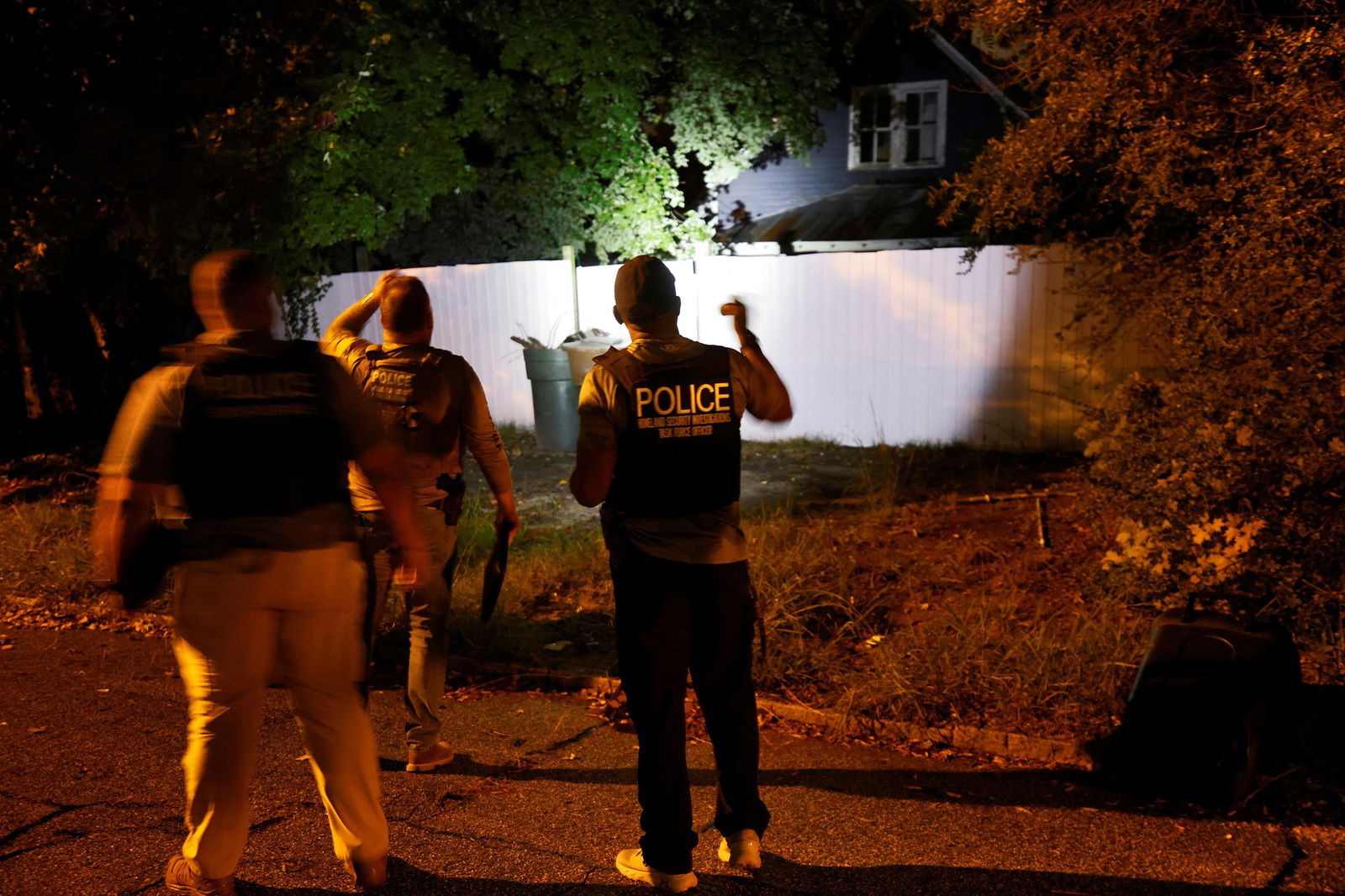 Police in the dark check a home