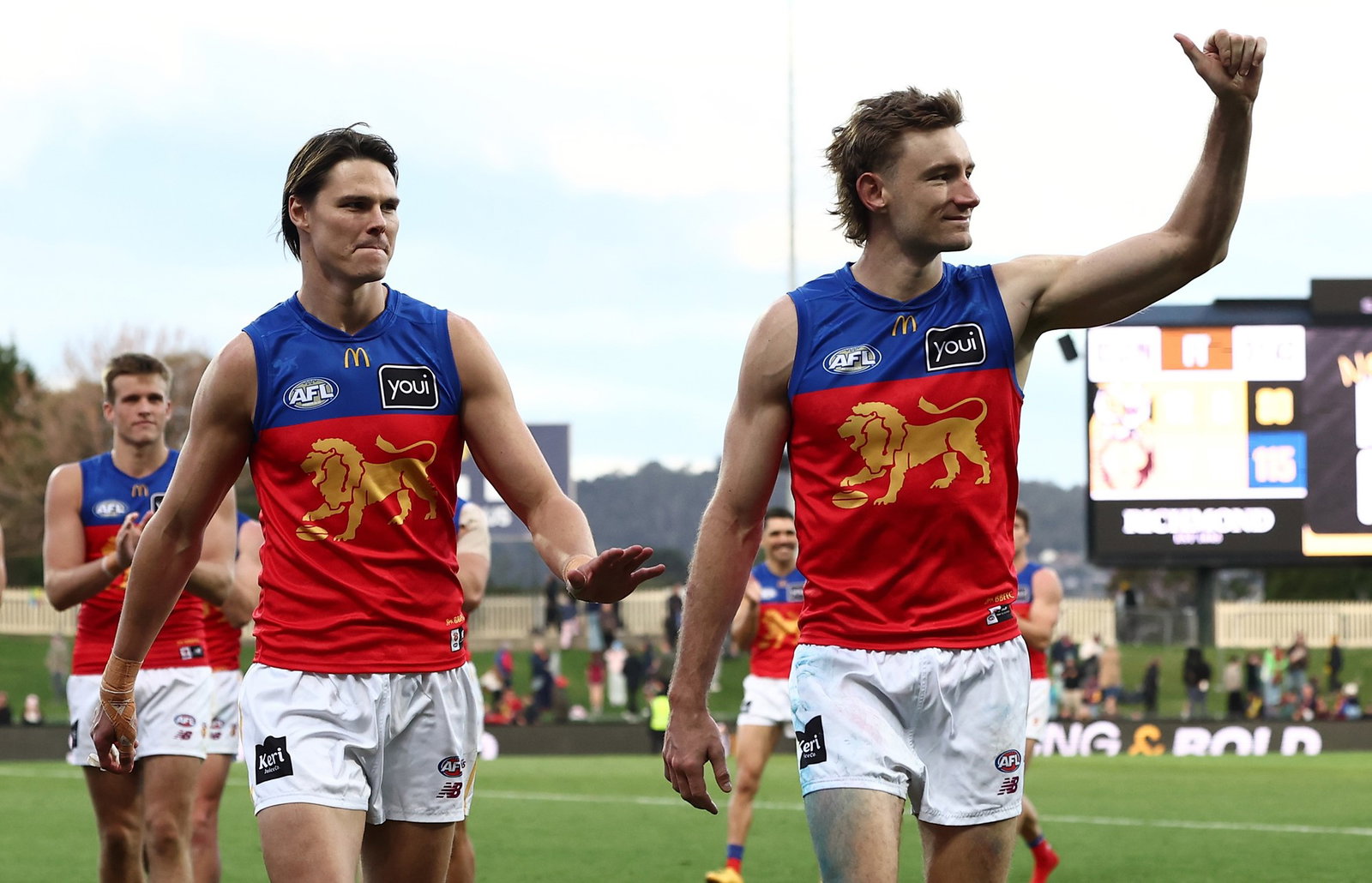 Eric Hipwood and Harris Andrews of the Lions leave the ground together in their milestone games during the 2026 AFL Round 14 match between the Richmond Tigers and the Brisbane Lions on June 14, 2026 in Hobart, Australia.