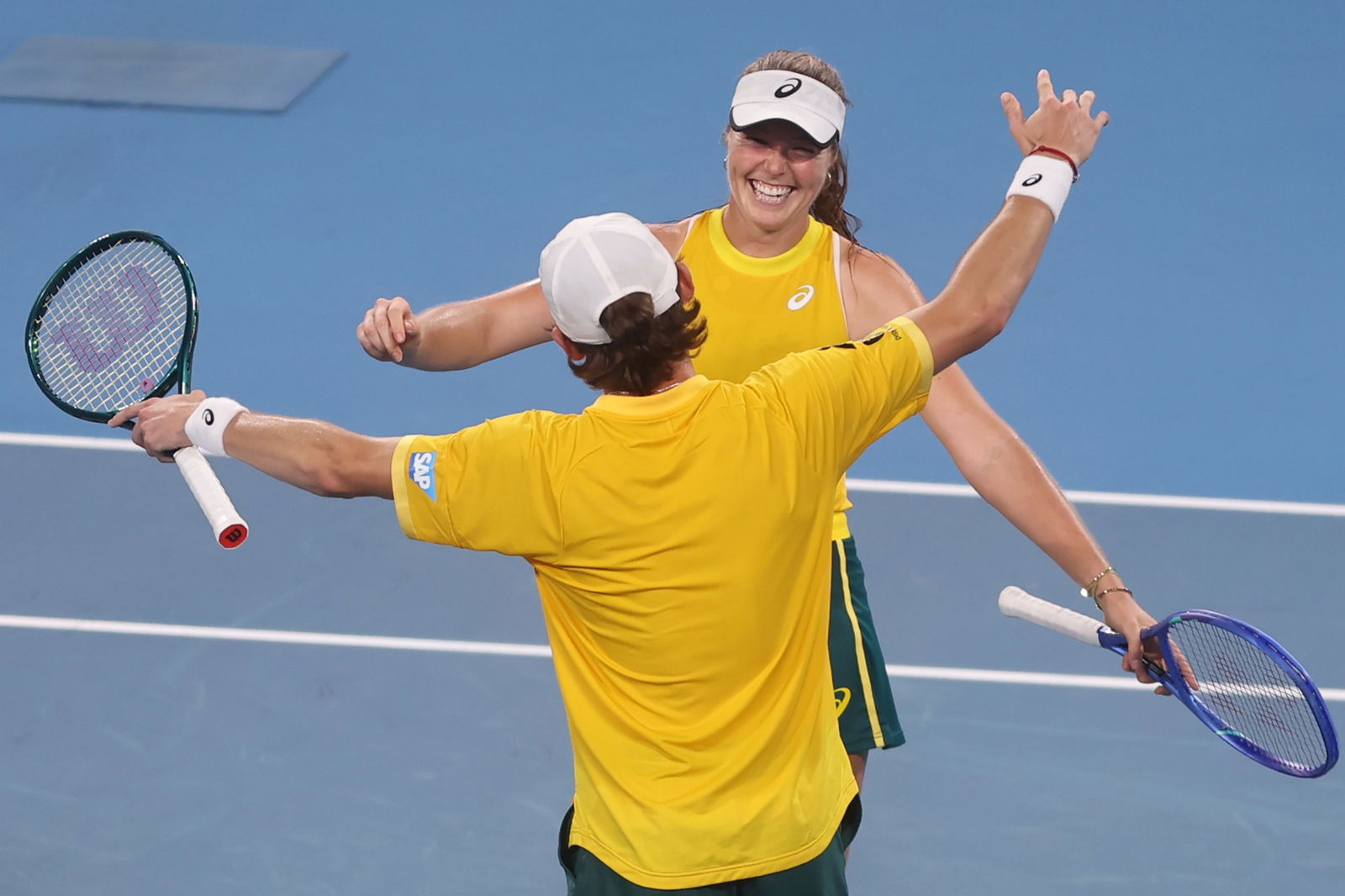 Alex de Minaur embraces Olivia Gadecki.