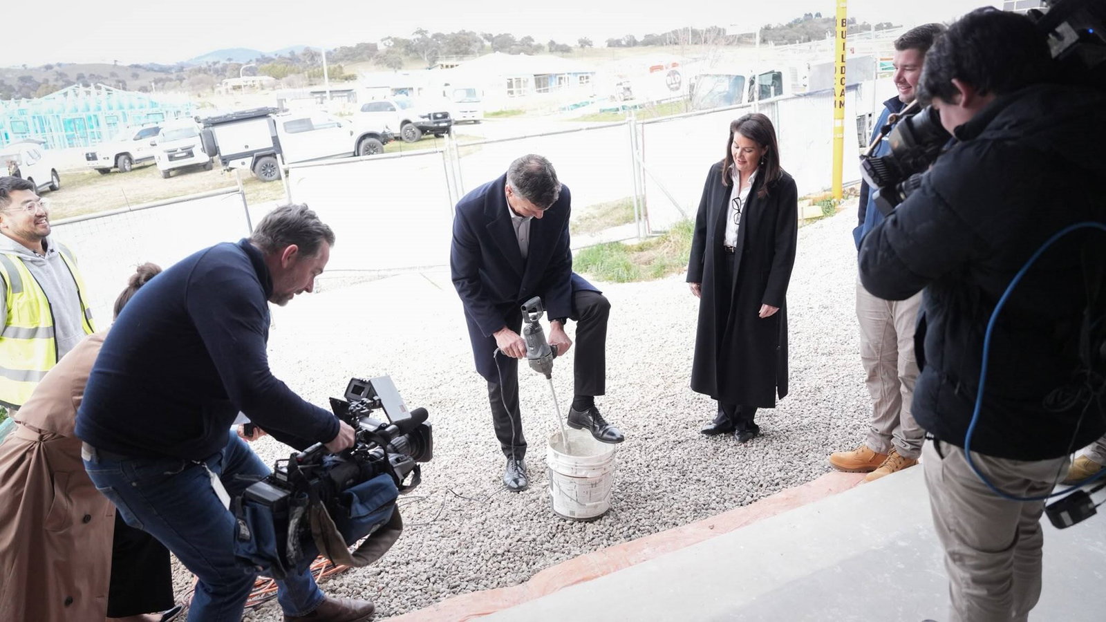 Angus Taylor gets on the mixing tools at at housing estate.