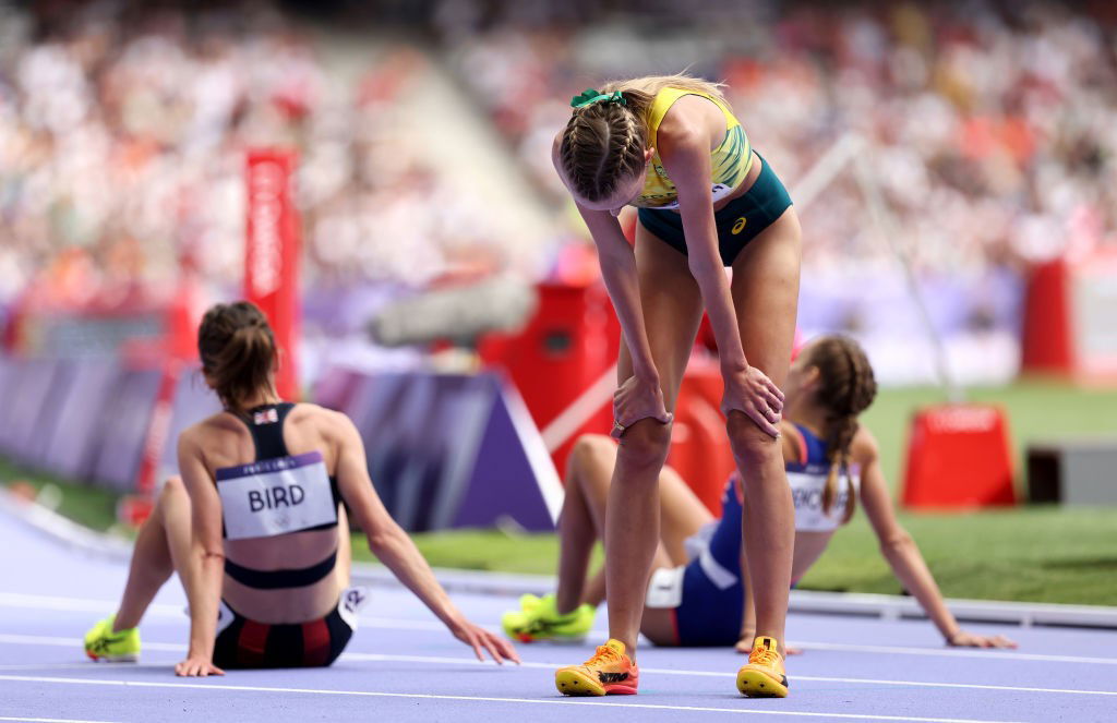 Cara Feain-Ryan slumps after the women's 3,000m steeplechase heat at the Paris Olympics.