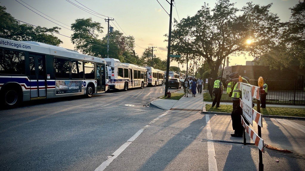 A wide shot of buses in traffic.