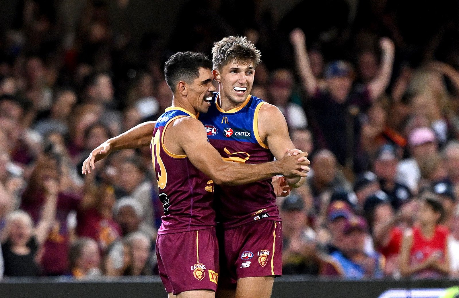 Zac Bailey and Charlie Cameron celebrate for Brisbane
