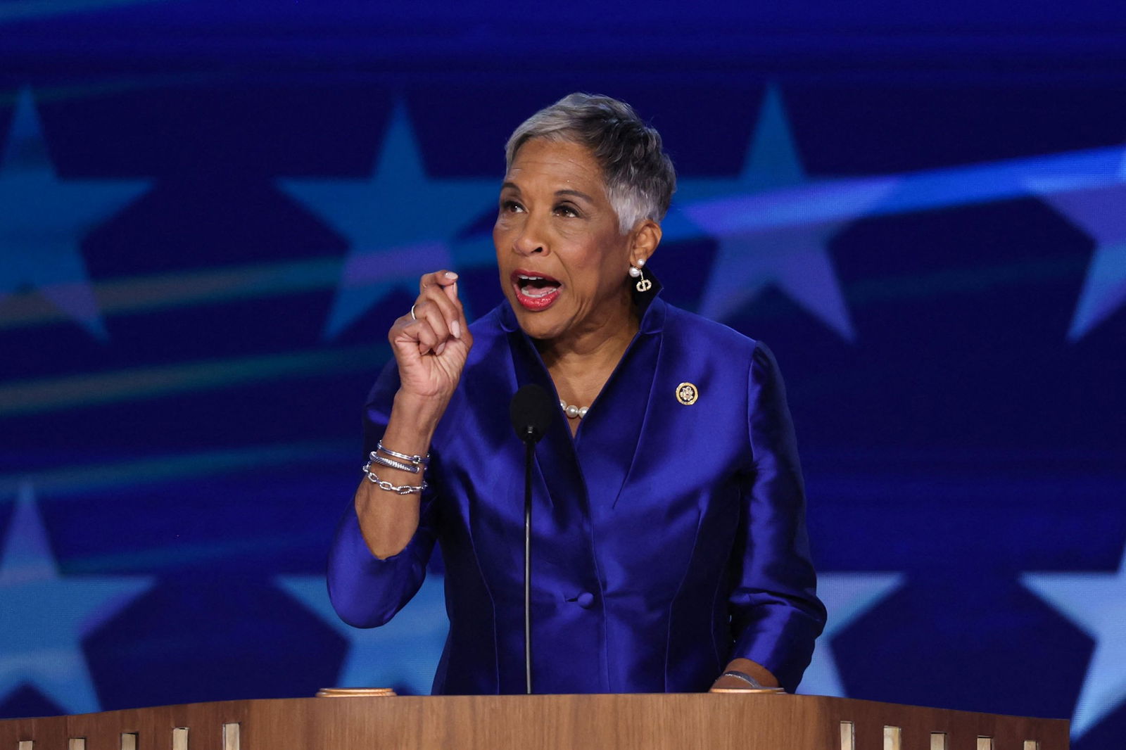 Joyce Beatty gestures with a raised hand as she speaks at a podium