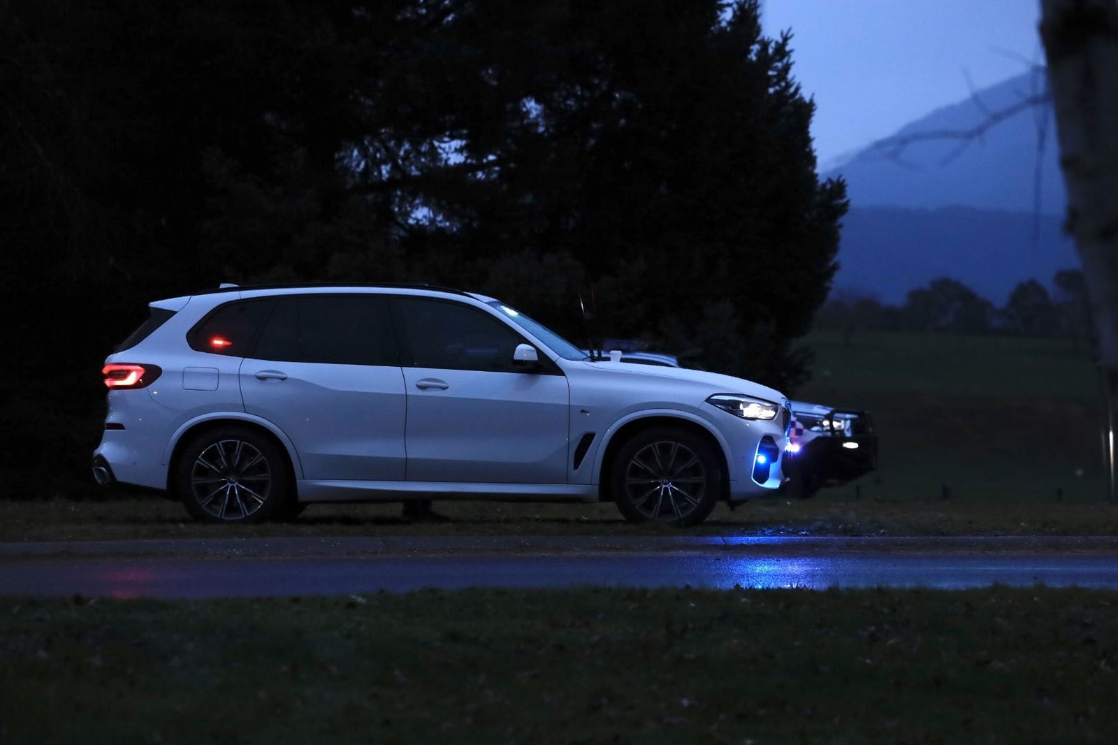 Two cars stationed near the crime scene.