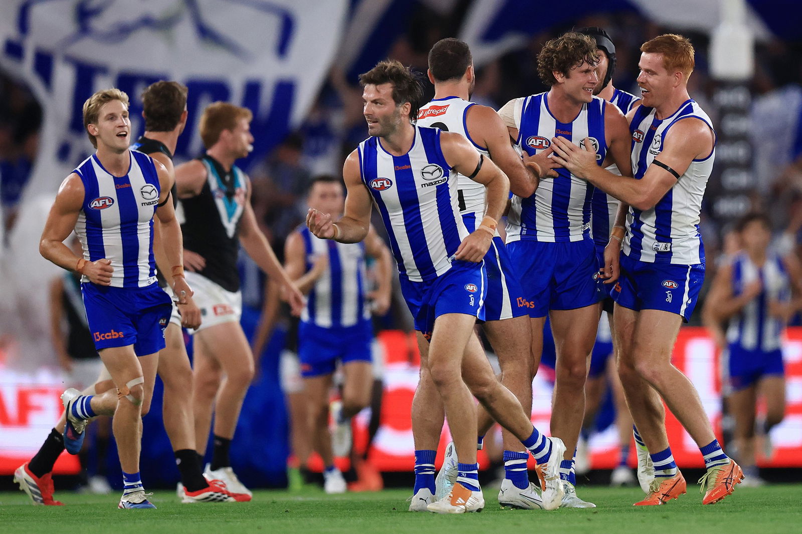 Kangaroos players celebrate a goal.