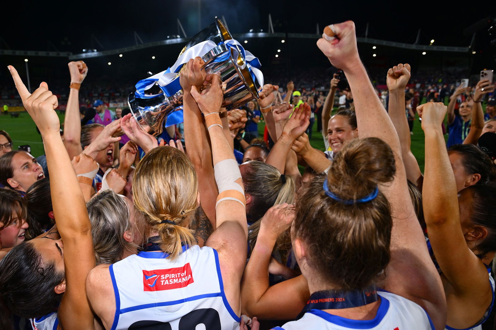 North Melbourne players celebrate with the cup