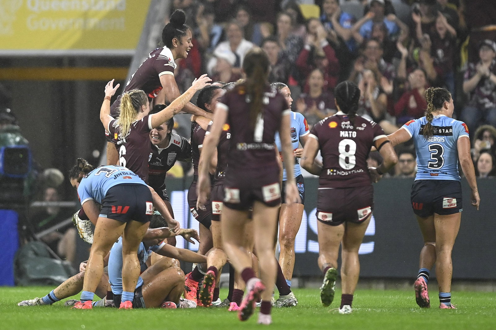 Queensland Maroons jump on Tazmin Rapana after a try in Women's State of Origin III.