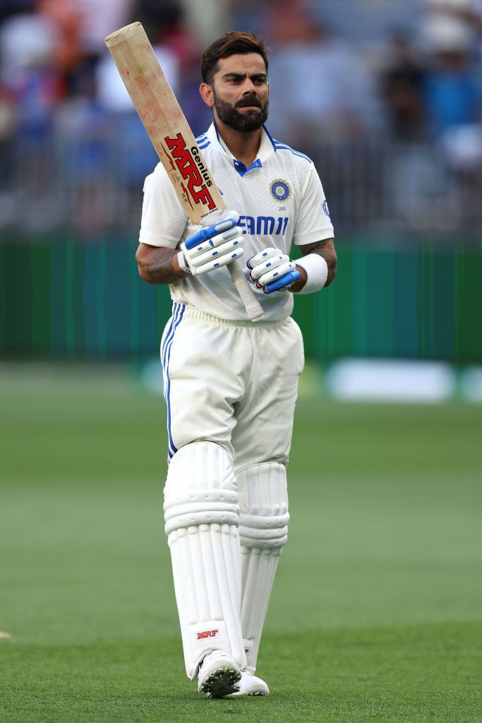 India batter Virat Kohli stands with his bat on the field.