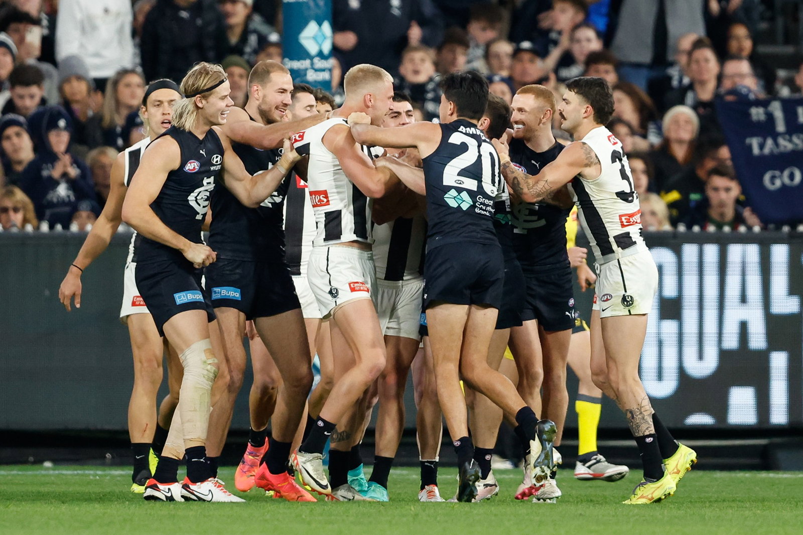 Carlton and Collingwood players fight