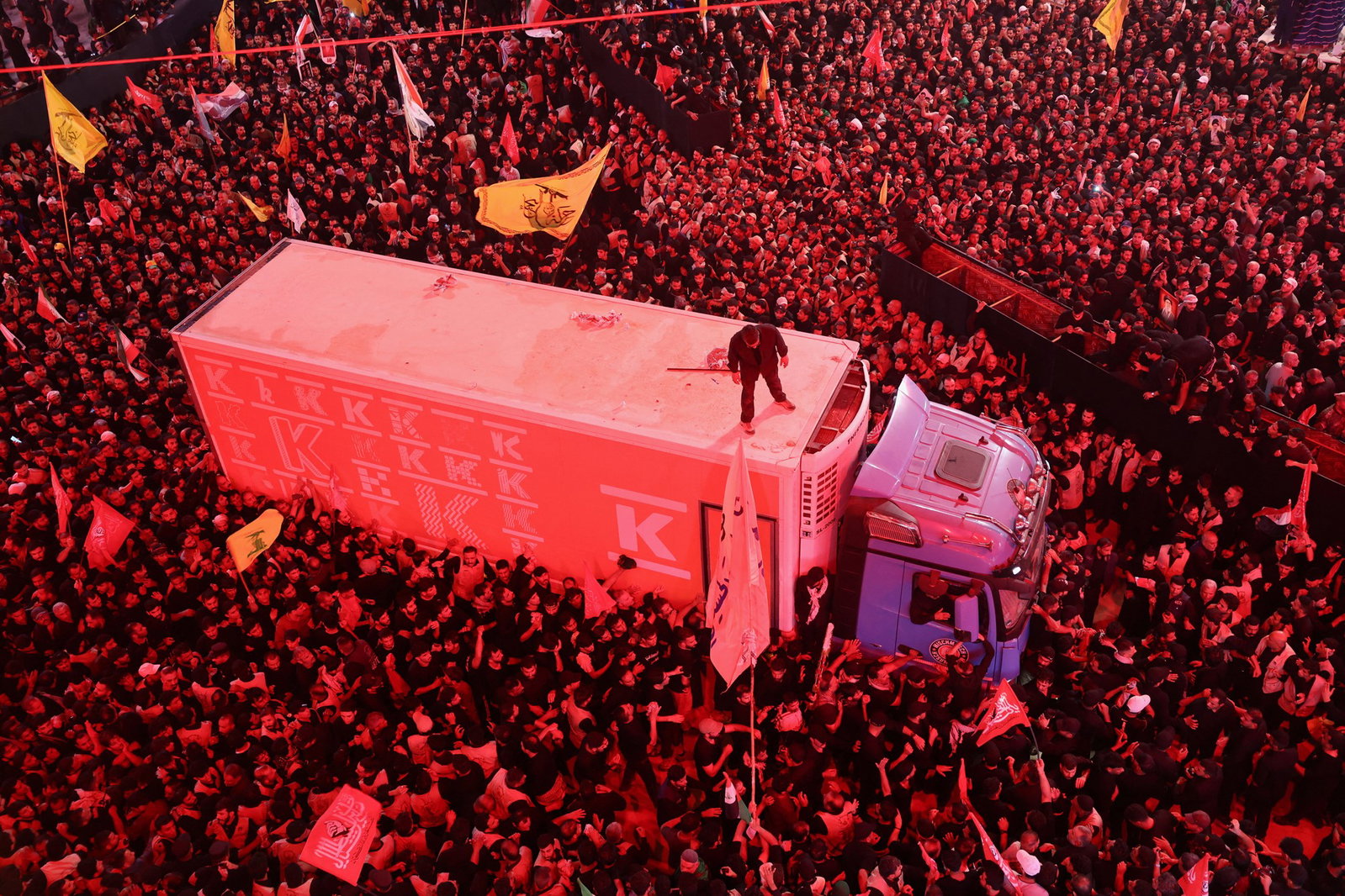A large crowd gathered around a refridgeration truck