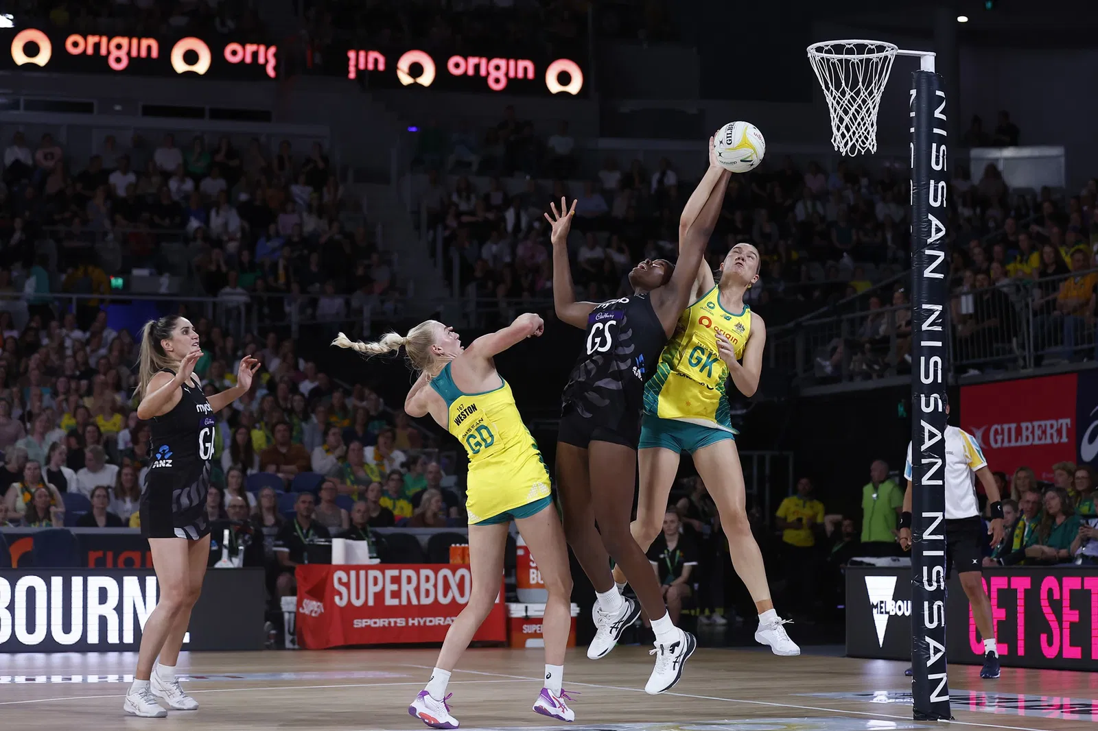 Three players contest the ball in the air.