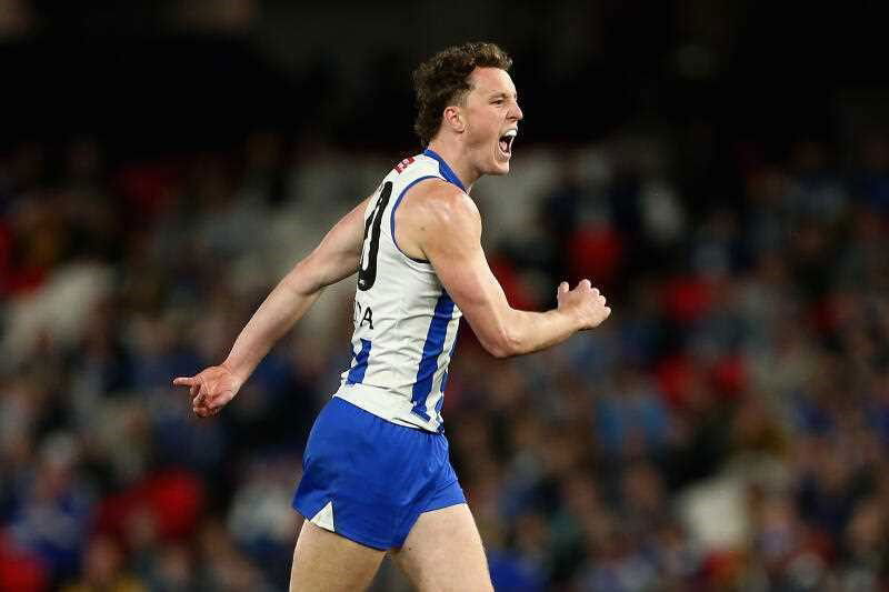Nick Larkey yelling with delight after kicking a goal in an AFL match at Docklands Stadium.