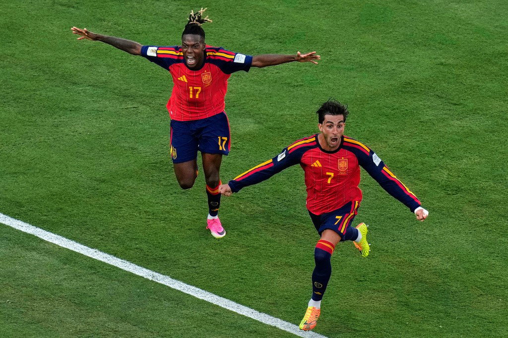 Williams and Torres celebrate the goal.