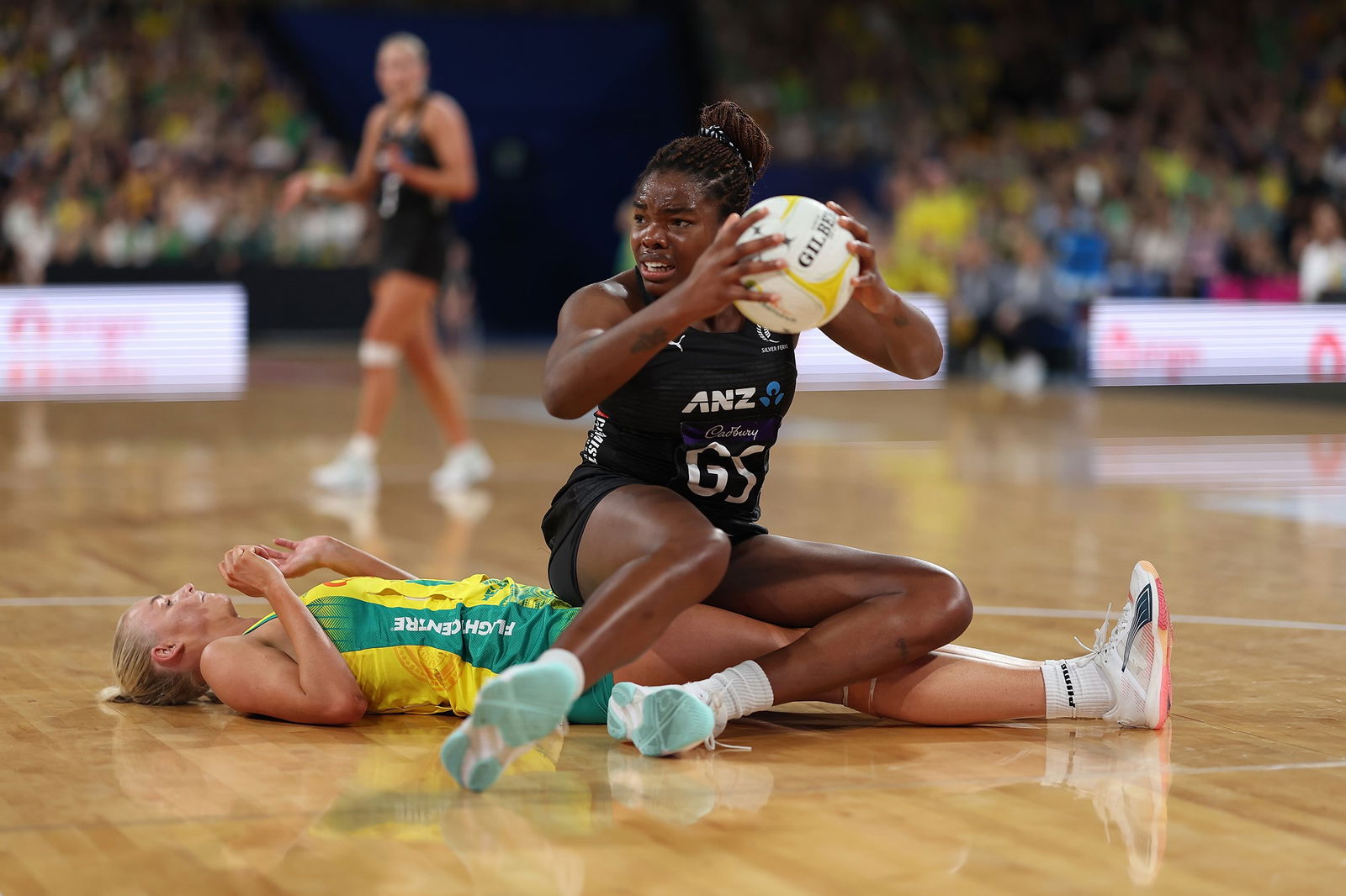 A player sits on top of another on court