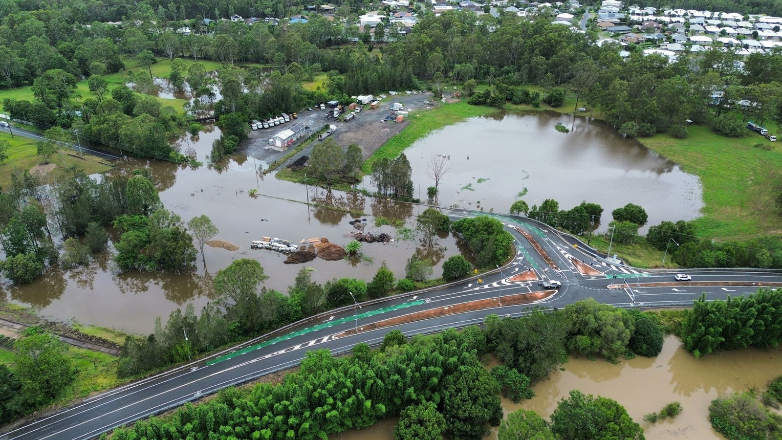 An aerial shot of a highway with flooding on either side