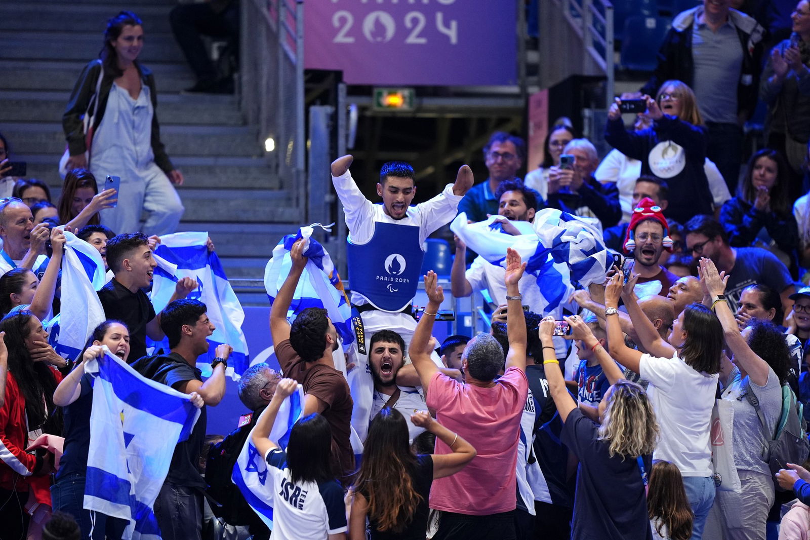 Israel's Asaf Yasur celebrates a gold medal win in men's K44-59kg taekwondo in Paris.