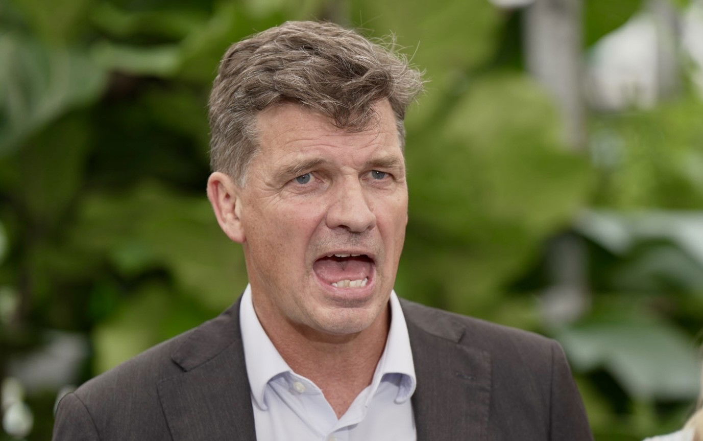 Angus Taylor stands with his mouth open.
