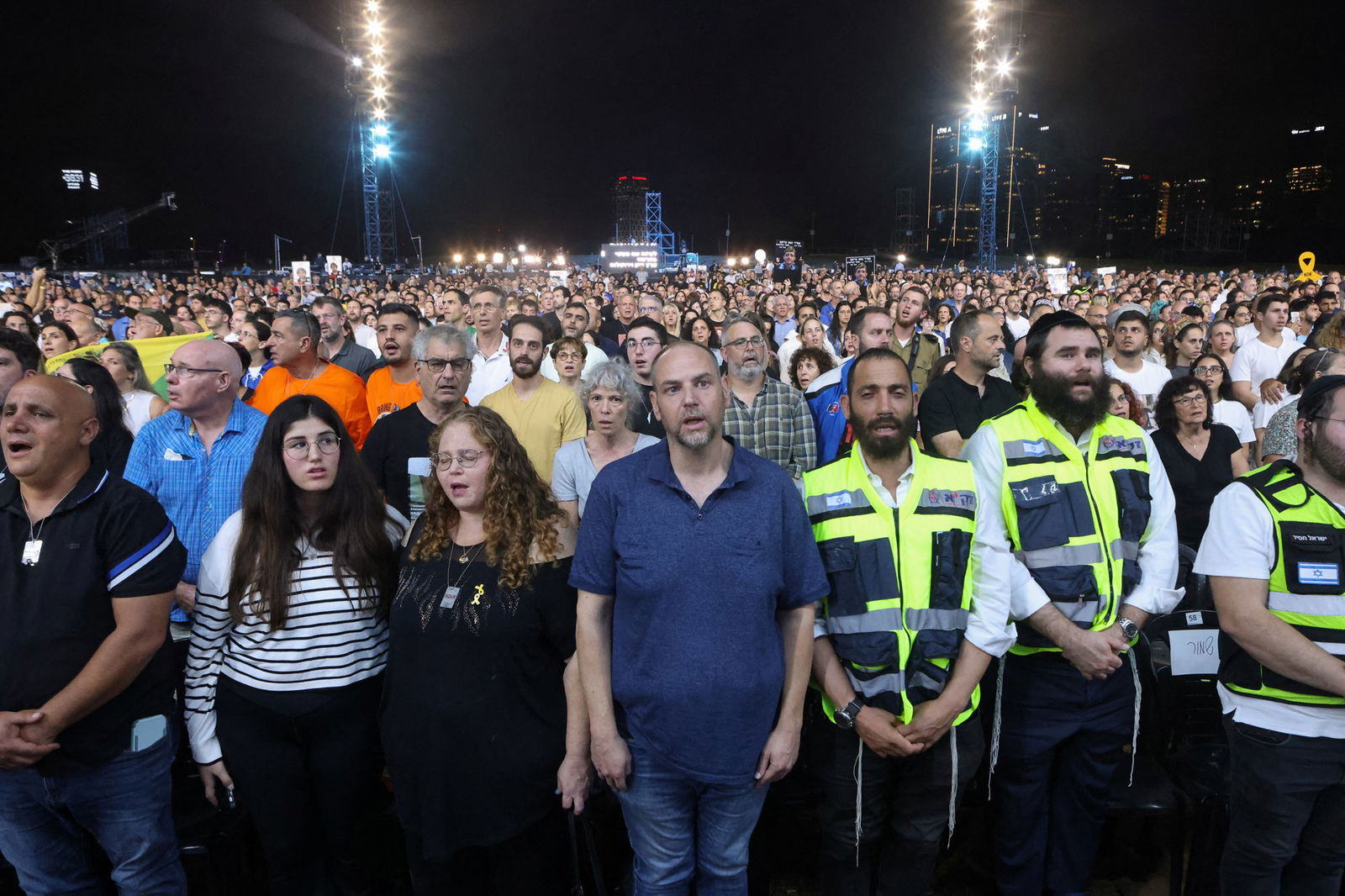 A large group of people singing. 