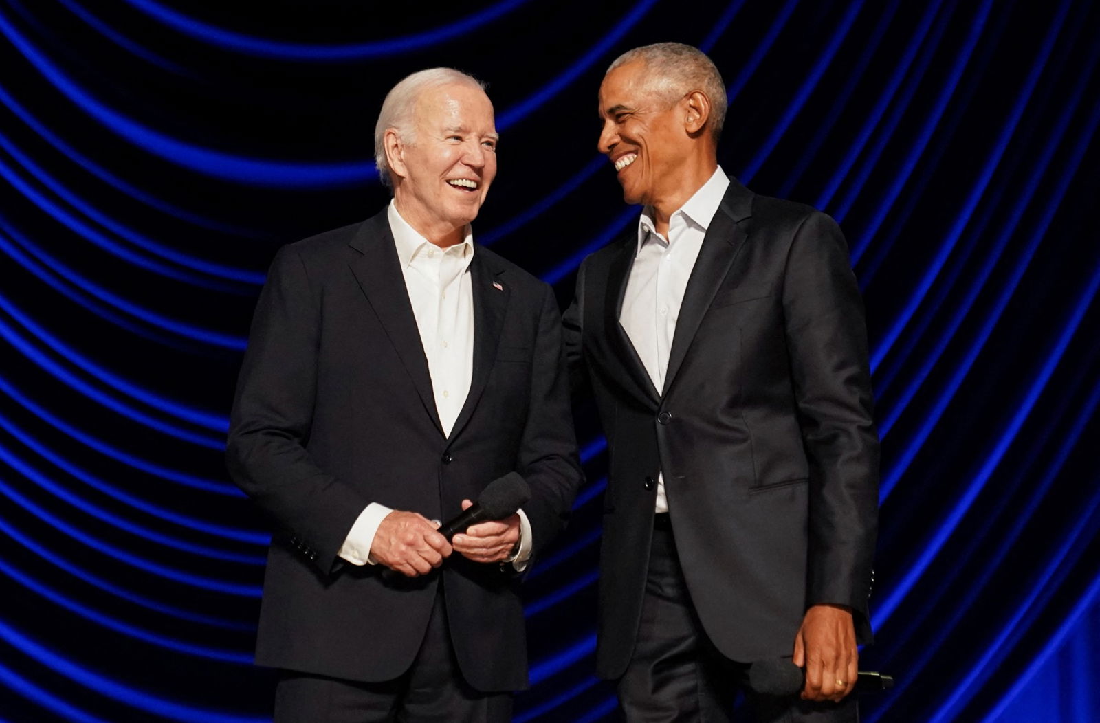 Biden and Obama laugh on stage