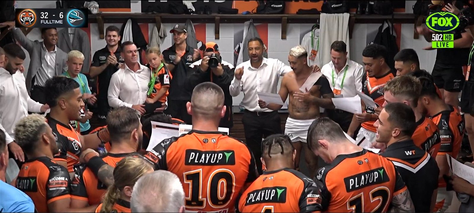 A screenshot of Tigers players and coaches singing the team song.