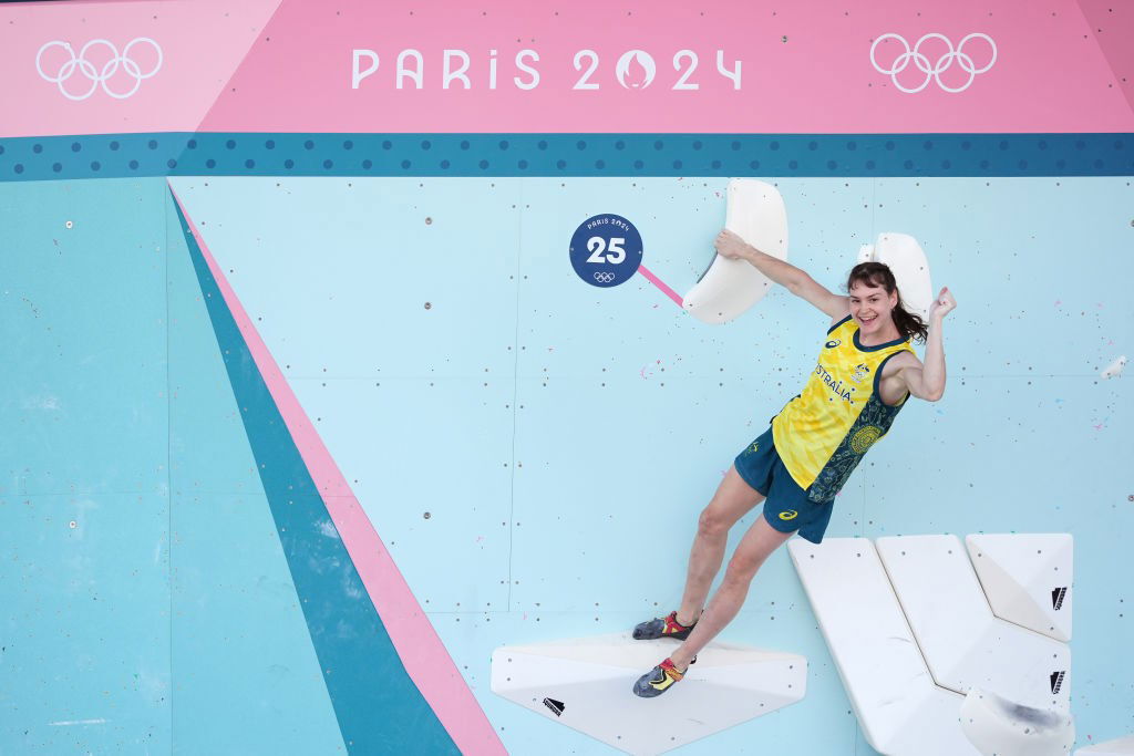 Oceania Mackenzie at the top of a boulder problem at the Paris Olympics.