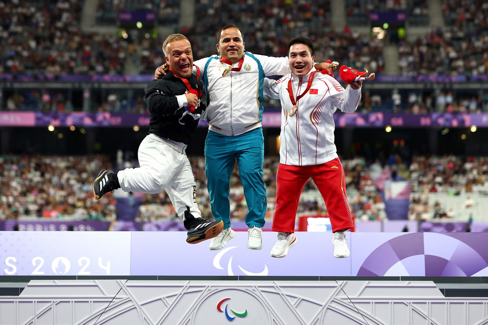 Gold medalist, Bobirjon Omonov of Team Uzbekistan (C), Silver medalist, Niko Kappel of Team Germany (L) and Jun Huang of Team People’s Republic of China (R) during the Men's Shot Put - F41 Final.