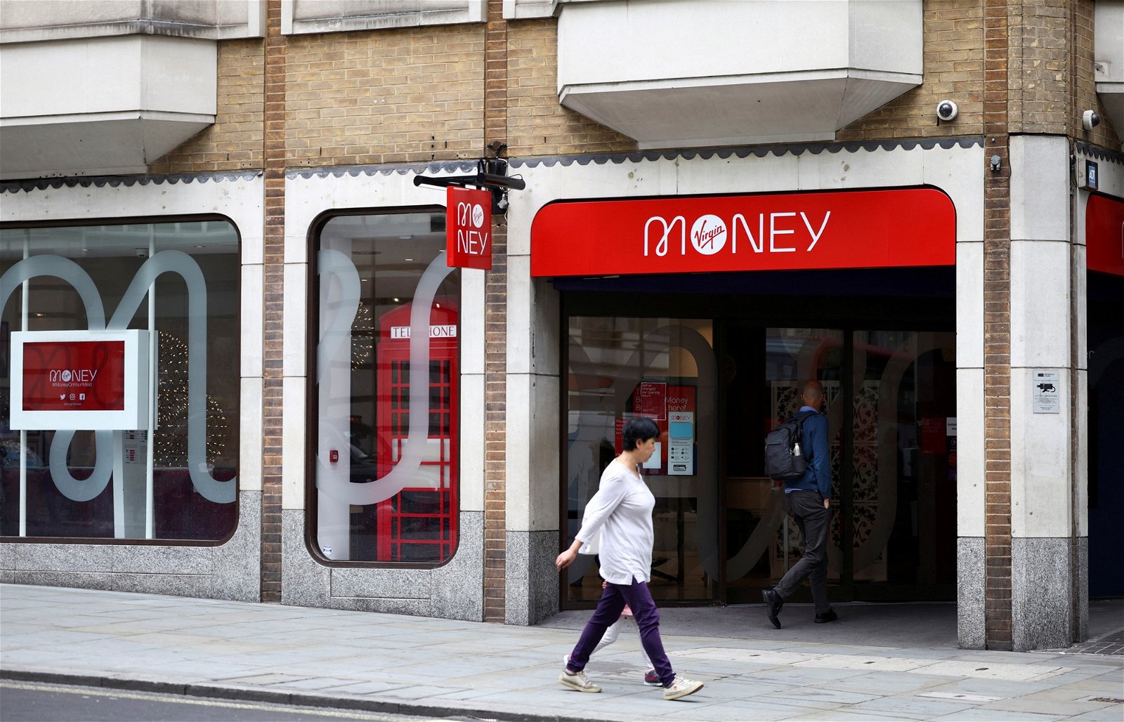 People walk past a Virgin Money bank branch in central London.