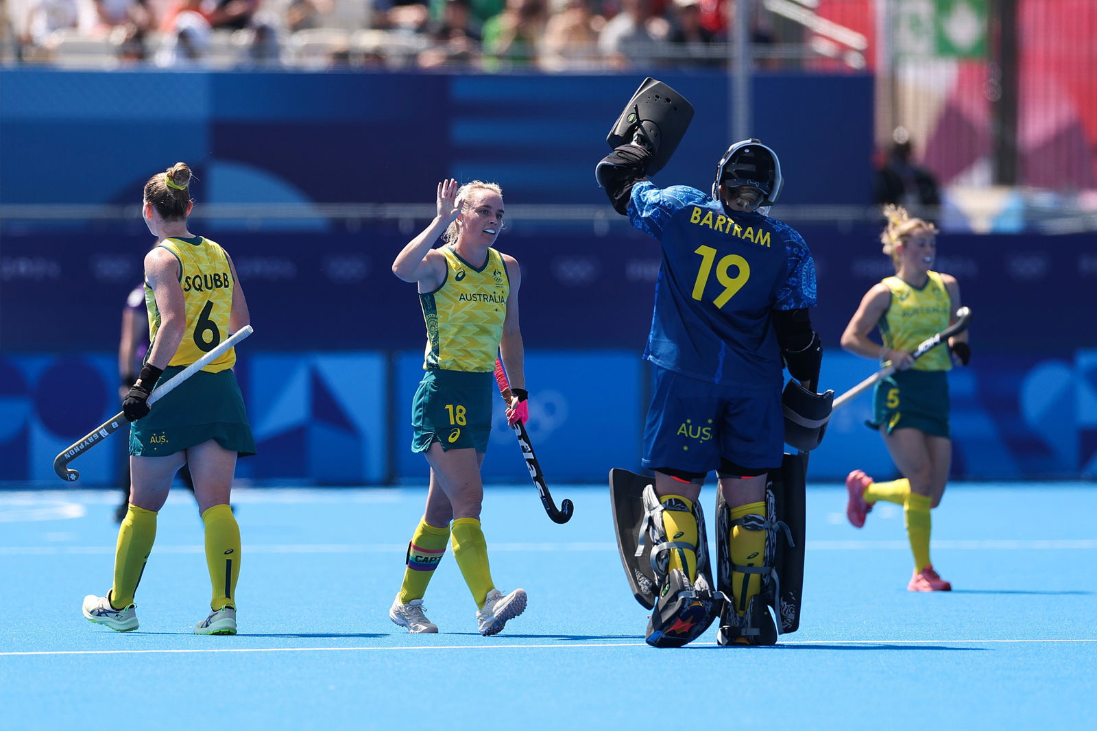 The Hockeyroos' Jane Claxton high-fives teammate Jocelyn Bartram at the Olympics