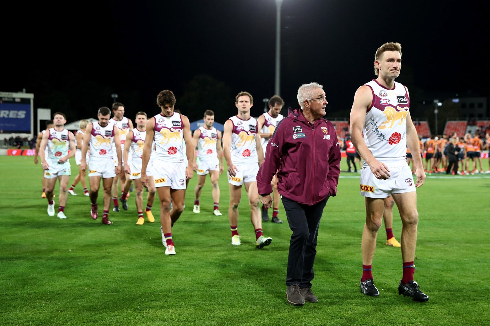 Brisbane's Chris Fagan and Harris Andrews look dejected as they walk off.
