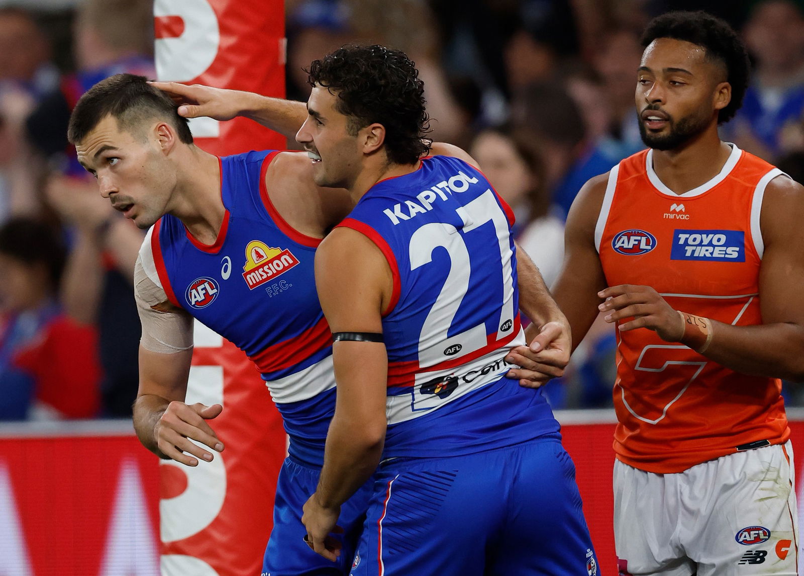 Sam Darcy is congratulated by a Bulldogs teammate.