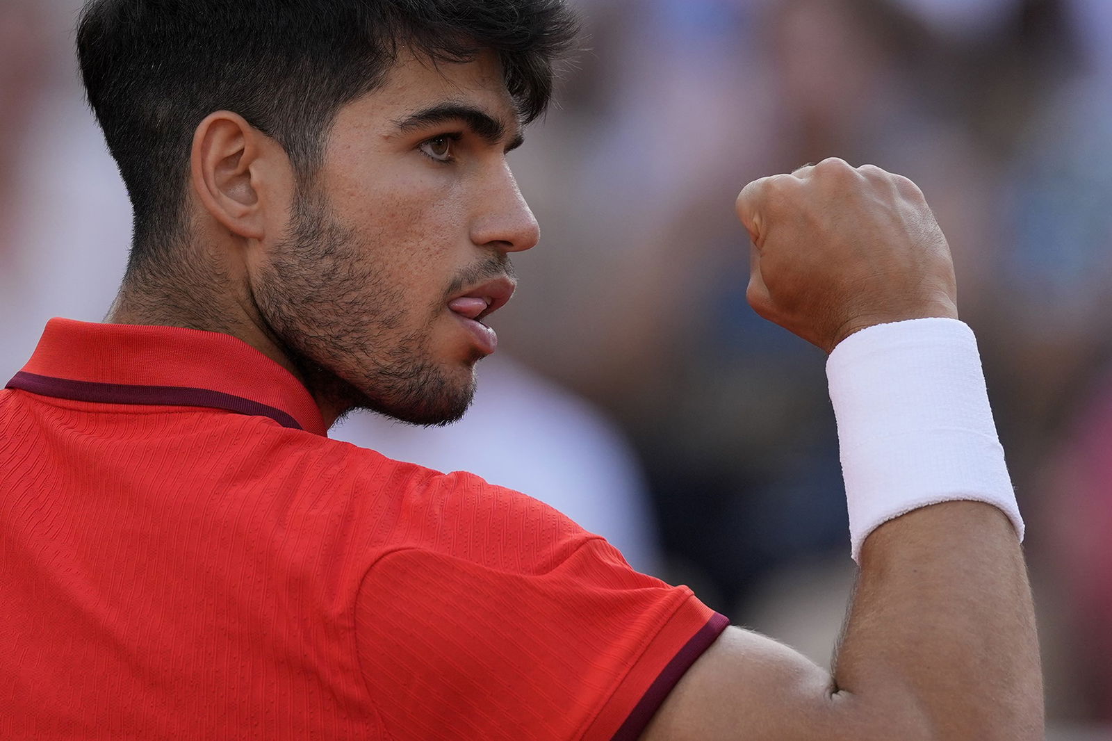 Carlos Alcaraz celebrates during a men's singles tennis match at the Paris Olympics.