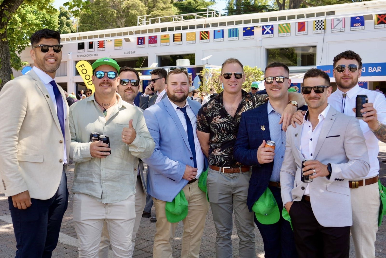 A group of men all smile at the camera.