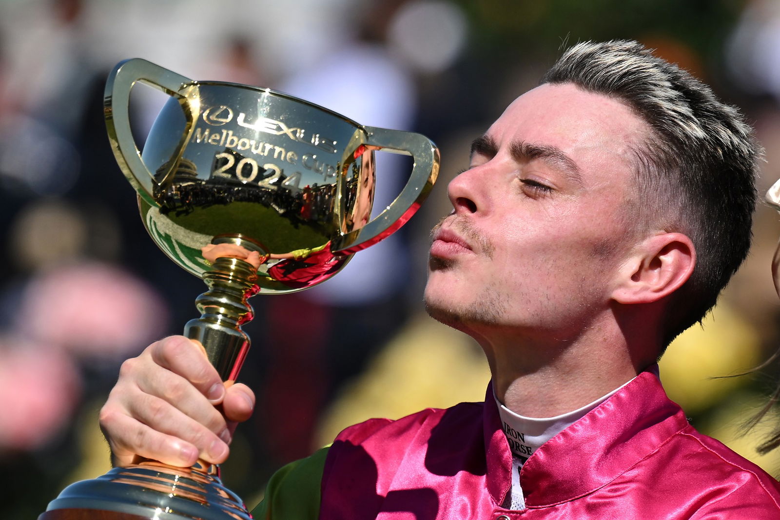 Jockey Robbie Dolan kisses the Melbourne Cup trophy.