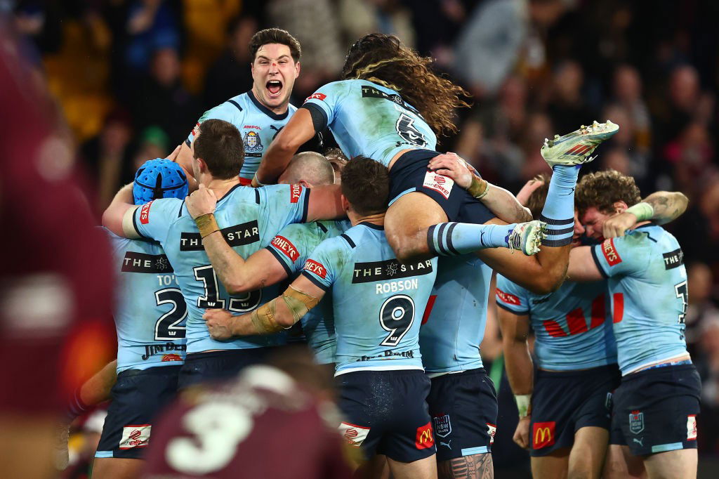 The NSW Blues jump on each other to celebrate winning the State of Origin decider.