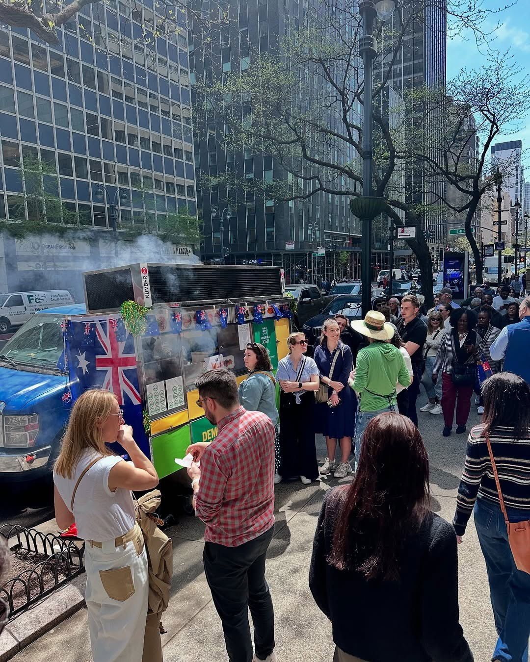 a group of people enjoying a sausage sizzle in a city