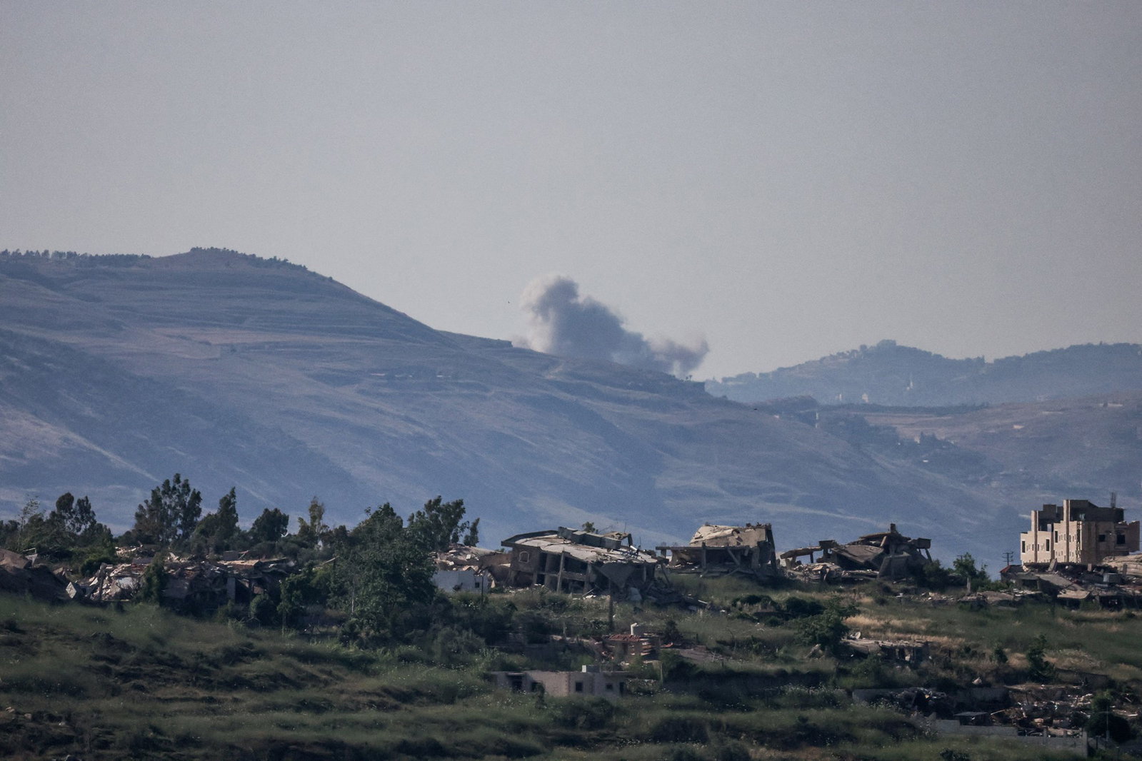 Smoke rises over a village