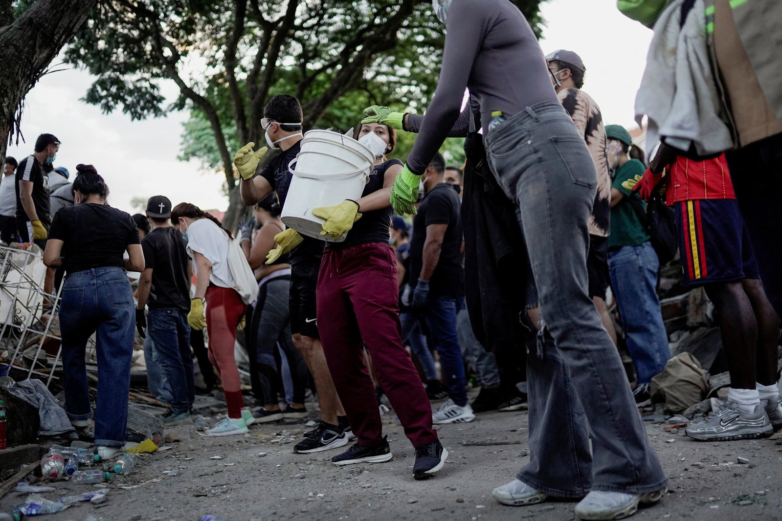 People forming a chain to help remove rubble