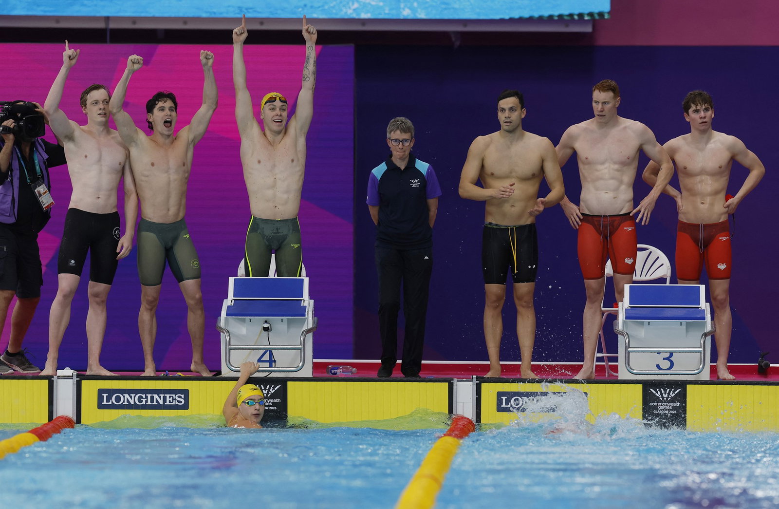 Aussie men relay team cheering while English team look sad beside them