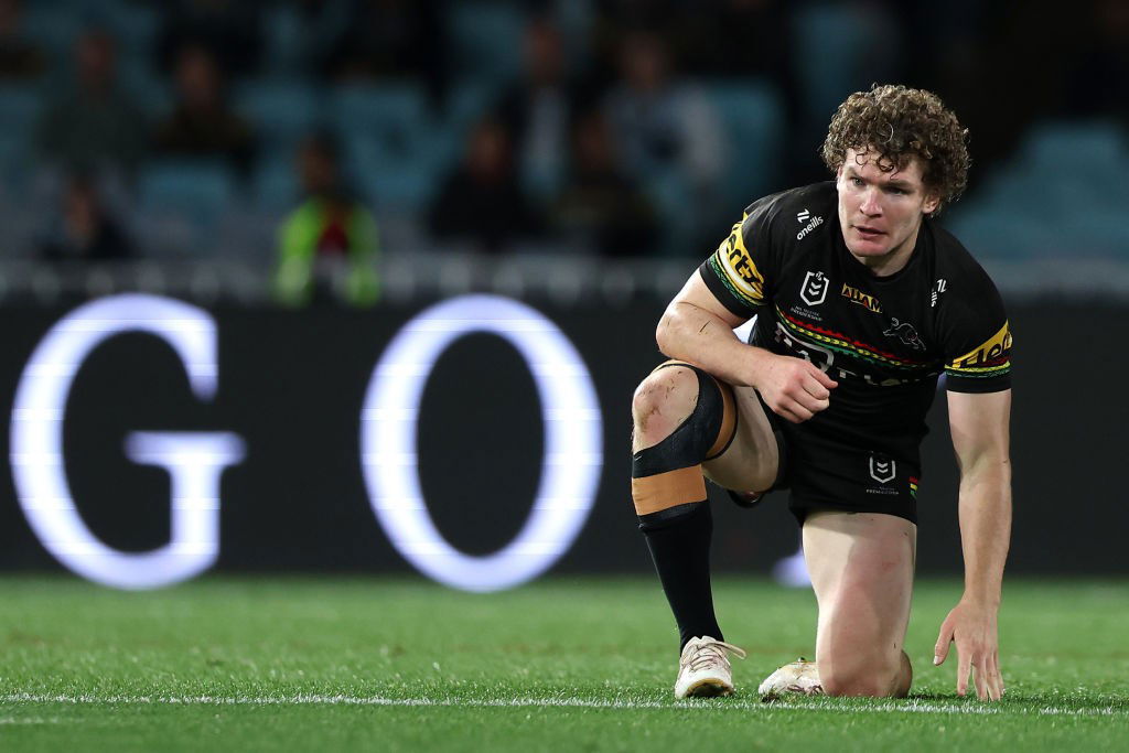 Penrith Panthers' Liam Martin kneels on the grass during an NRL game.