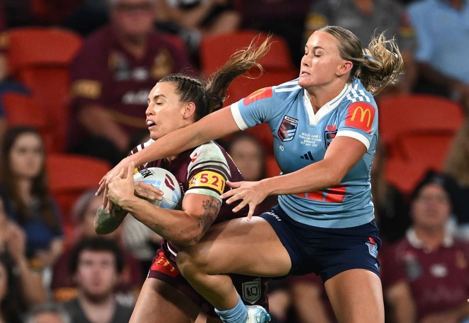 Julia Robinson of Queensland and Jaime Chapman of NSW compete for a ball in Women's State of Origin.