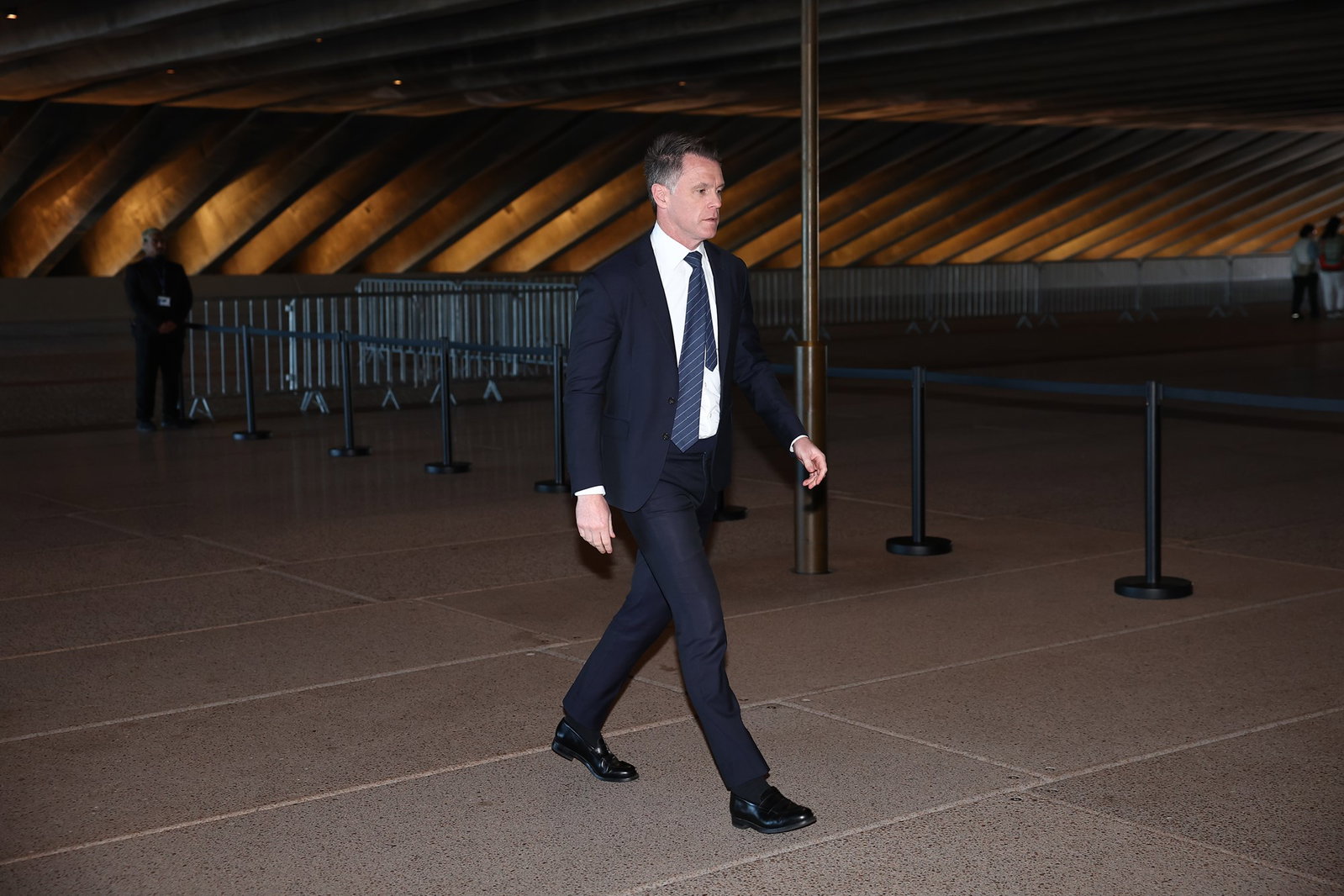NSW Premier Chris Minns walks in dark suit