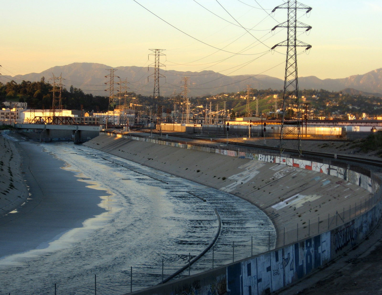 Shallow water in the Los Angeles River at sunset.