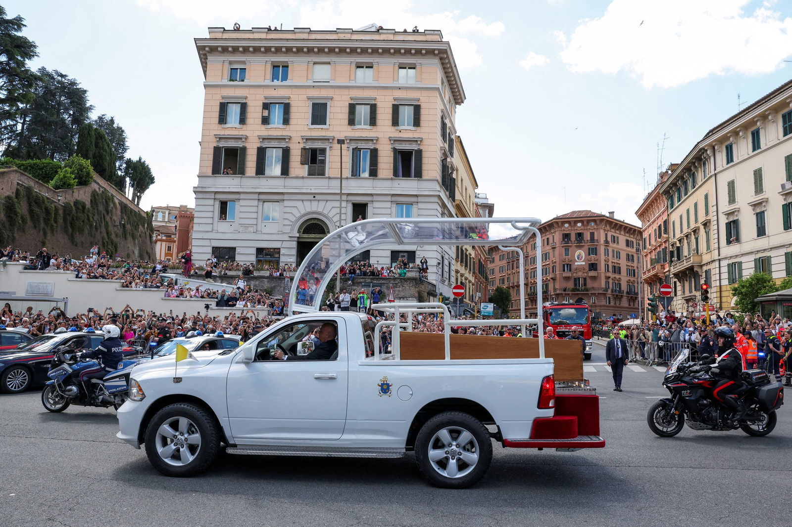 A white hearse carrying a coffin.