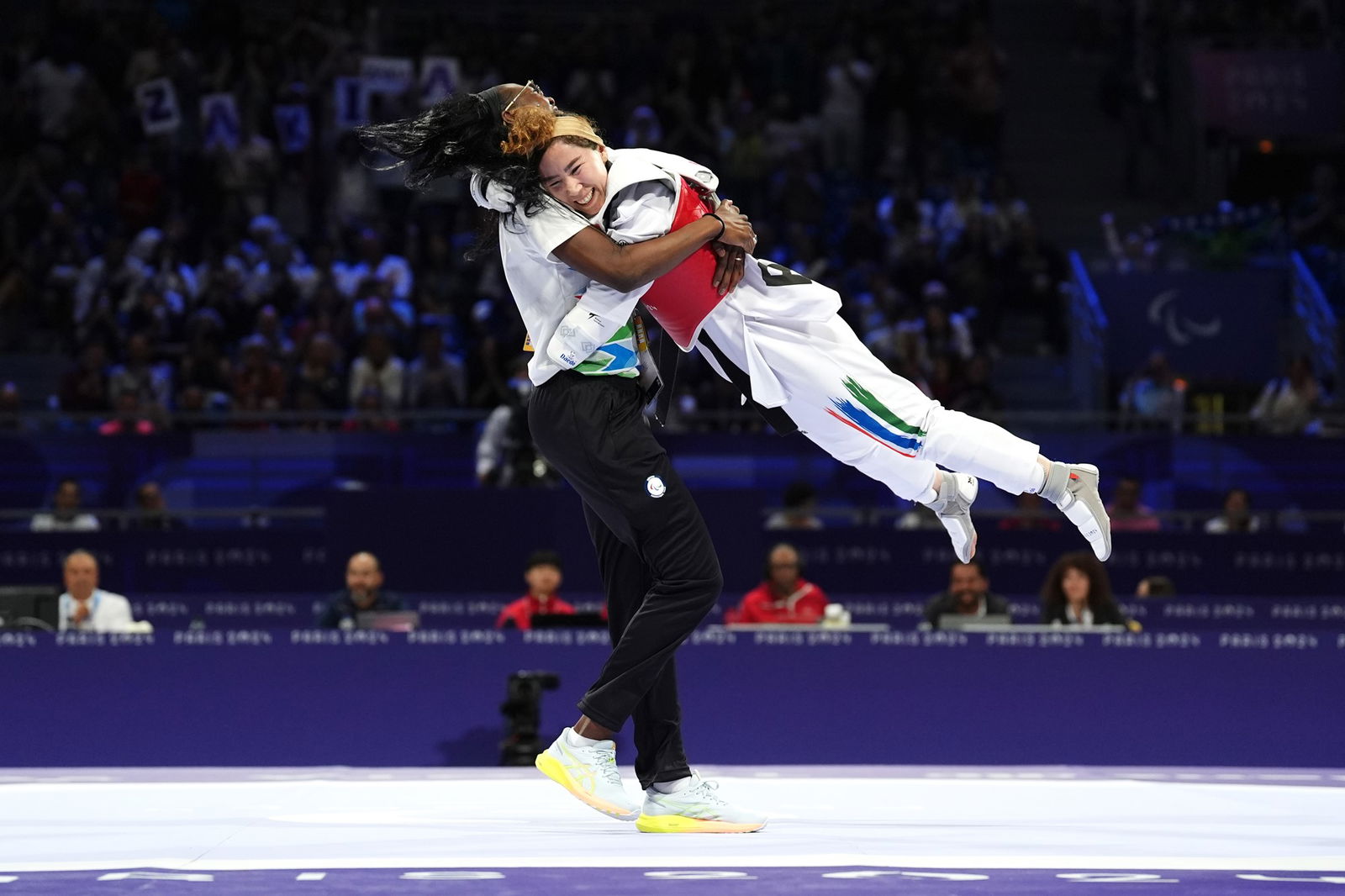 Zakia Khudadadi of the Refugee Paralympic Team celebrates gold in women's K44-47kg taekwondo in Paris.