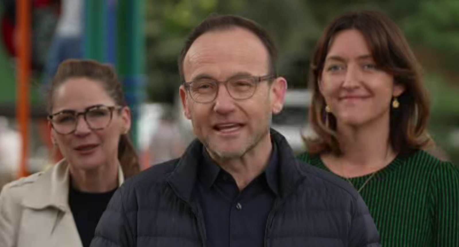 Adam Bandt is flanked by Sonya Semmens and Steph Hodgins-May in front of a playground.